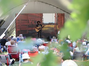 Sunny War is seen performing through leaves from the nearby oak trees on the Little Stage in the Forest on the final day of the 46th annual Winnipeg Folk Festival at Birds Hill Provincial Park, north east of Winnipeg, Man., on  July 14, 2019.