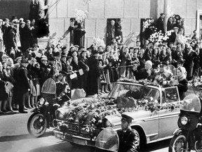 Soviet Cosmonaut Yuri Gagarin, accompanied by his wife Valentina and Soviet leader Nikita Khrushchev, salutes the crowd, which gathered May 1, 1961, to celebrate Gagarin's historic space flight.