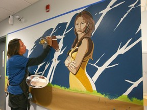 Artist Kalum Teke Dan completes a painting in the main area at the The Brenda Strafford Centre in Calgary.