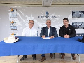 From left, Claudio Palumbo, vice-president of Qualico Communities in Calgary, Chestermere Mayor Marshall Chalmers, and Bob Faktor, vice-president, land development, for Anthem United, sign an agreement to front-end the capital cost of the second phase of the Rainbow Road sanitary trunk.
