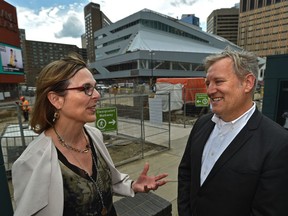 Edmonton Public Library CEO Pilar Martinez (left), and architect Carol Belanger talk about the Stanley A. Milner library's new look as construction on the renovation continues in the background on July 16, 2019.