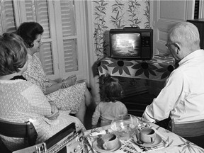 Like families around the world, a family in Paris watches as U.S. astronaut Neil Armstrong, commander of Apollo 11, sets his foot on the moon July 20, 1969.