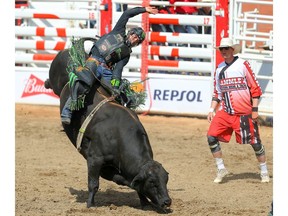 Brazilian cowboy Jose Vitor Leme hangs on tight for an 91 on a bull named Rebel Soul during the bull-riding event at the Calgary Stampede rodeo on Thursday, July 11, 2019. Al Charest / Postmedia