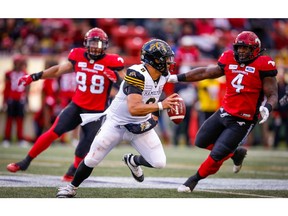 Hamilton Tiger-Cats Jeremiah Masoli throws an interception to Brandon Smith while under pressure from James Vaughters and Micah Johnson, during CFL football in Calgary on Saturday, June 16, 2018. Al Charest/Postmedia