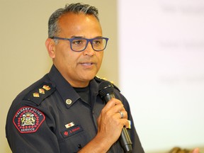 Sat Parhar with the Calgary Police Service speaks to members of the community during a Town Hall Meeting on Public Safety & Community Violence at the Genesis Centre to address concerns around public safety and crime and violence reduction around the northeast. Tuesday, July 23, 2019. Brendan Miller/Postmedia