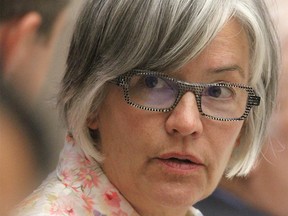 Calgary Coun Druh Farrell chats with a fellow council member at City Council Tuesday, July 30, 2019. Jim Wells/Postmedia