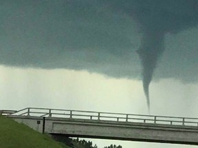 FILE - A funnel cloud near Crossfield on Sunday, July 14, 2019.