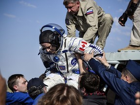 Astronaut David Saint-Jacques is helped out of the Soyuz MS-11 capsule shortly after landing in a remote area in Kazakhstan on June 25, 2019.