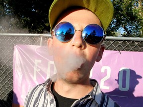 Ben Deere is seen smoking in the cannabis consumption area during the 40th Annual Calgary Folk Music Festival at Prince's Island Park on Thursday, July 25, 2019. Brendan Miller/Postmedia
