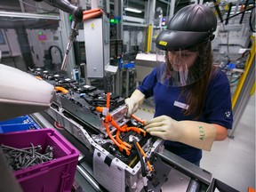 An employee assembles lithium-ion battery modules at the Bayerische Motoren Werke AG (BMW) automobile manufacturing plant in Dingolfing, Germany. An Alberta company is developing a way to process lithium from oilfield brine, says columnist Danielle Smith.
