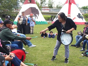 During a demonstration of a traditional Indigenous hand game at Elbow River Camp, Karen Three Suns snags a stick from Noran Calf Robe, putting her team in the lead.
