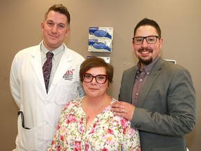 Heart patient Michelle Kotelko and her husband Keith pose for a photo with Dr. Brian Clarke, a heart specialist at Foothills Medical Centre. Kotelko has a new wireless sensor implanted into the pulmonary artery of her heart.