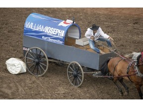 Kurt Bensmiller takes down a barrel in Heat 9 of the Rangeland Derby chuckwagon races at the Calgary Stampede in Calgary on Saturday. Photo by Mike Drew/Postmedia.