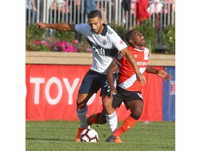 Whitecaps FC Ali Al-Tammemi (left) battles with Cavalry FC Elijah Adekugbe (R) during first half CPL soccer Canadian Championship action between the Vancouver Whitecaps and Cavalry FC at ATCO Field at Spruce Meadows in Calgary on Wednesday, July 10. Jim Wells/Postmedia