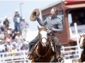 Dawson Hay from Wildwood,AB, riding Trail Smoke was the winner during the Saddle Bronc event on day 6 of the 2019 Calgary Stampede rodeo in Calgary on Wednesday, July 10, 2019. Darren Makowichuk/Postmedia