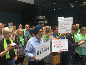 Members of Keep Calgary Strong protest potential budget cuts to Calgary Transit after being told they couldn't address Calgary city council on Monday, July 22, 2019. (Sammy Hudes/Postmedia)