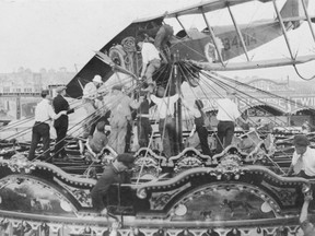 A Curtiss Jenny is checked after it crash-landed on top of the carousel at the Calgary Stampede in 1919. First World War flying ace Freddie McCall was giving a ride to the two young sons of Exhibition manager E. L. Richardson when he lost power. Rather than land on the infield, where an auto race was under way, or among the Stampede crowds, he brought the plane down on top of the carousel. No one was injured. Postmedia archive