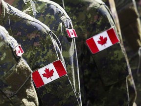 Members of the Canadian Armed Forces march during the Calgary Stampede parade in Calgary on July 8, 2016. The federal government is paying $900 million to settle multiple class-action lawsuits lodged on behalf of survivors of sexual harassment, gender discrimination and sexual assault in the military.