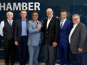 Calgary Mayor Naheed Nenshi and Ken King shake hands with L-R, councillors, Ward Sutherland, John Bean. President & CEO, Jeff Davison and Shane Keating as council voted for a new arena in Calgary on Tuesday, July 30, 2019. Darren Makowichuk/Postmedia