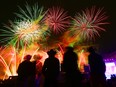 Visitors take in the fireworks at the Calgary Stampede at the end of the night Sunday evening, July 7, 2019.