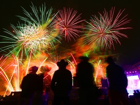 Visitors take in the fireworks at the Calgary Stampede at the end of the night Sunday evening, July 7, 2019.