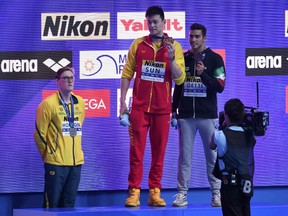 Silver medallist Australia's Mack Horton (L) refuses to stand on the podium with gold medallist China's Sun Yang (C) and bronze medallist Italy's Gabriele Detti after the final of the men's 400m freestyle event during the swimming competition at the 2019 World Championships at Nambu University Municipal Aquatics Center in Gwangju, South Korea, on July 21, 2019.