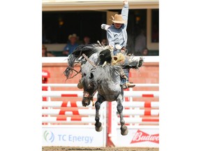 Wildwood's Dawson Hay rides Chin Lee to a score of 88 in Day 8 of the Calgary Stampede rodeo saddle-bronc event on  Friday. Photo by Al Charest/Postmedia.