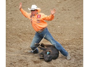 Matt Shiozawa, of Chubbuck, Idaho, tied with Timber Moore for top-spot with a time of 7.0 seconds in the tie-down roping event on Wild Card Saturday at the Calgary Stampede. Both cowboys advance to Showdown Sunday. Photo by Al Charest/Postmedia.