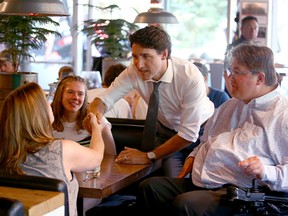 Prime Minister Justin Trudeau and Calgary MP Kent Hehr meet patrons during a stop at The Beltliner Diner in downtown Calgary on Friday, July 12, 2019.