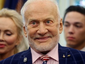 Former astronaut Buzz Aldrin smiles as U.S. President Donald Trump honors him, Michael Collins and their family members during an Apollo 11 moon landing 50th anniversary commemoration in the Oval Office of the White House in Washington, U.S., July 19, 2019.