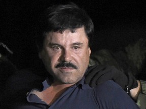 Drug kingpin Joaquin "El Chapo" Guzman is escorted into a helicopter at Mexico City's airport following his recapture in 2016.