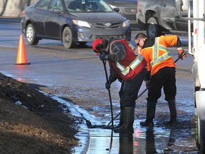 City of Calgary crew clears a storm drain along Crowchild Trail.