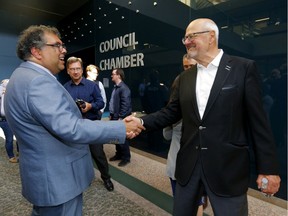 Mayor Naheed Nenshi and Ken King shake hands as council voted for a new arena in Calgary on Tuesday, July 30, 2019.