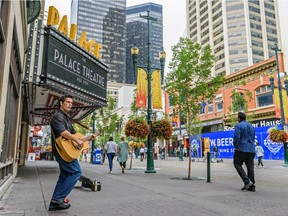 Busker James Inman plays guitar outside Palace Theatre on Stephen Avenue on Wednesday, Aug. 7, 2019.