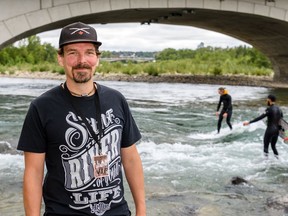 Neil Egsgard, president of Alberta River Surfing Association and Surf Anywhere poses for a photo by the Bow River during the Slam Festival in Calgary on Saturday, August 10, 2019. Azin Ghaffari/Postmedia Calgary
