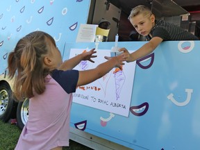 Haylen Astalos sells McFlurries for donations in support of Ronald McDonald House in CalgaryÕs Sandy Beach Park on Sunday August 18, 2019. Haylen, 9, has raised over $30,000 for the charity with his own driveway ice cream stand since his 5th birthday and McDonaldÕs surprised Haylen with a visit from the McFlurry truck to help with his fundraising efforts. Gavin Young/Postmedia