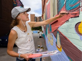 Artist Mary Haasdyk works on her mural at 17 Avenue S.W. on Friday, August 23, 2019. Haasdyk is one of the artists at the 2019  Beltline Urban Murals Project festival in Calgary.