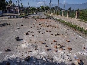 SRINAGAR, KASHMIR, INDIA - AUGUST 18: Stones thrown by Kashmiri protesters at Indian forces lie in the road in the Habba Kadal after a protest against revocation of Article 370 and Article 35A, on August 18, 2019 in Srinagar, the summer capital of Indian administered Kashmir, India.  Curfew like restrictions remain in place in Kashmir for the fourteenth consecutive day after India revoked articles 370 and 35A, and phone and internet services also remained suspended. Article 35A of the Indian Constitution was an article that empowered the Jammu and Kashmir state's legislature to define permanent residents of the state and provided special rights and privileges to those permanent residents, also preventing non-locals from buying or owning property in the state. Prior to 1947, Jammu and Kashmir was a princely state under the British Empire. It was added to the Constitution through a Presidential Order. The Constitution Order 1954, (Application to Jammu and Kashmir) was issued by the President of India on 14 May, 1954 in accordance with Article 370 of the Indian Constitution, and with the concurrence of the Government of the State of Jammu and Kashmir. Kashmir has been a state under siege, with both India and Pakistan laying claim to it. Human rights organizations say more than 80,000 have died in the two decade long conflict with the Indian government claiming the number as 42,000. (Photo by Yawar Nazir/ Getty Images)