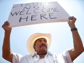 EL PASO, TEXAS - AUGUST 07: Miguel de Anda, born and raised in El Paso, holds a sign reading 'Trump Not Welcome Here' at a protest against President Trump's visit following a mass shooting, which left at least 22 people dead, on August 7, 2019 in El Paso, Texas. Trump is scheduled to visit the city today. A 21-year-old white male suspect remains in custody in El Paso which sits along the U.S.-Mexico border.