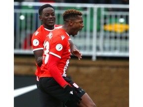 Dominique Lamonga (R) celebrates his second goal of the game with teammate Nathan Mavila (L) during Canadian Premier League soccer action between Cavalry FC and Halifax Wanderers FC at ATCO Field at Spruce Meadows in Calgary on Saturday, May 25, 2019. Cavalry won 2-0 and remain undefeated. Jim Wells/Postmedia