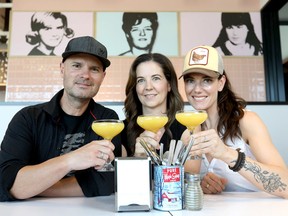 L-R, John and Carrie Jackson with their partner Connie DeSousa from Chix Eggshop. The pop art behind them is a tribute to their three moms. Darren Makowichuk/Postmedia