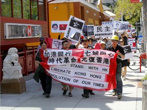 Over 100 Calgarians came out for the Stand with Hong Kong rally which took place from Chinatown to the Chinese Consulate in Calgary on Sunday, August 4, 2019. Darren Makowichuk/Postmedia