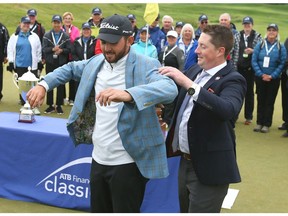 Hayden (L) tries on the winners jacket after capturing the ATB Financial Classic at Country Hills Golf Club on Sunday, August 11, 2019. He won in a one hole playoff. Jim Wells/Postmedia  Jim Wells/Postmedia