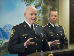 Canadian Association of Chiefs of Police president Adam Palmer, left, speaks while Calgary Police Chief Mark Neufeld listens during the association's annual conference at the Hyatt Regency hotel.