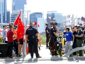 The Canada Save Hong Kong team held a rally on Crescent Rd. were Chinese supporters showed up and held an anti-rally as police were called in to keep it civil in Calgary on Saturday, August 17, 2019. Darren Makowichuk/Postmedia