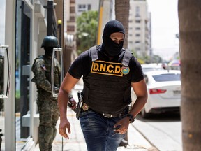 An agent of the Dominican National Drug Control Board (DNCD) and a soldier take part in the dismantling operation of a drug trafficking network, in Santo Domingo, on August 20, 2019. - Among the dozens of people involved in the network are Dominican Major League former baseball players Octavio Dotel and Luis Castillo. The operation is the 'broadest and deepest' in the fight against drug trafficking in the country, Dominican Prosecutor Jean Alain Rodriguez said. (Photo by Erika SANTELICES / AFP)ERIKA SANTELICES/AFP/Getty Images