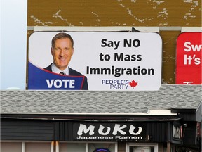 A billboard opposing "mass immigration" featuring the portrait of PPC Leader Maxime Bernier is displayed on 14th Street N.W. near Kensington Road on Sunday, Aug. 25.