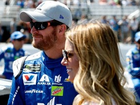 Dale Earnhardt Jr., driver of the #88 Nationwide Chevrolet, stands with his wife Amy on the grid prior to the Monster Energy NASCAR Cup Series Overton's 301 at New Hampshire Motor Speedway on July 16, 2017 in Loudon, New Hampshire.