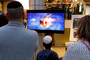 People watch a screen showing explanations of the landing of Israeli spacecraft, Beresheet’s, at the Planetaya Planetarium in the Israeli city of Netanya, on April 11, 2019 before it crashed during the landing. (Photo by JACK GUEZ / AFP)JACK GUEZ/AFP/Getty Images