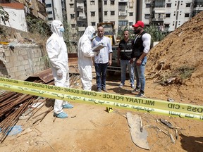 This picture taken on August 25, 2019 shows forensic investigators of Lebanon's military intelligence inspecting the scene where two drones came down in the vicinity of a media centre of the Shiite Hezbollah movement earlier in the day. - Hezbollah said on August 25 that one of the drones was rigged with explosives and caused damage to its media centre, but denied shooting down any of them. The early morning incident came hours after Israel launched air strikes in neighbouring Syria, but Hezbollah officials could not confirm if the drones deployed in Lebanon were Israeli. Another Hezbollah source told AFP the Iran-backed Shiite militant group -- a major political player in Lebanon with representatives in parliament and the government -- has not determined if the drones were Israeli. (Photo by ANWAR AMRO / AFP)ANWAR AMRO/AFP/Getty Images